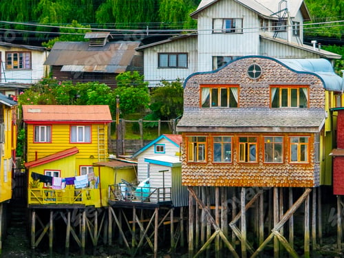 Preview: Houses Built On Stilts, Known Locally As Palafitos, Lining The Waters Edge In Castro, Capital Of