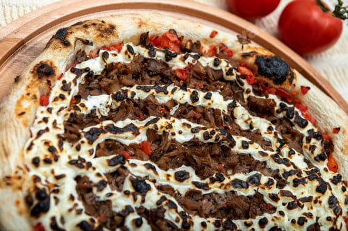 Preview: Shimeji Mushroom And Cream Cheese Pizza And Cooking Ingredients: Tomatoes And Olive Oil On Table