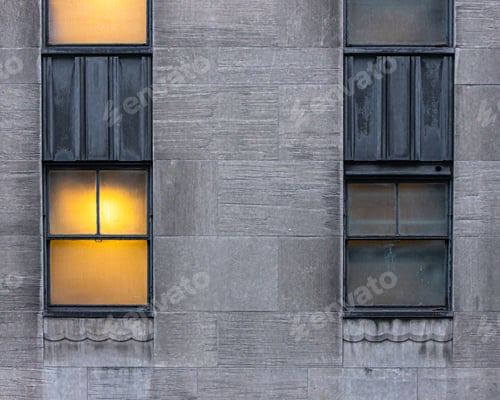 Preview: Symmetrical Windows, One Lit And One Dark On Urban Buildings