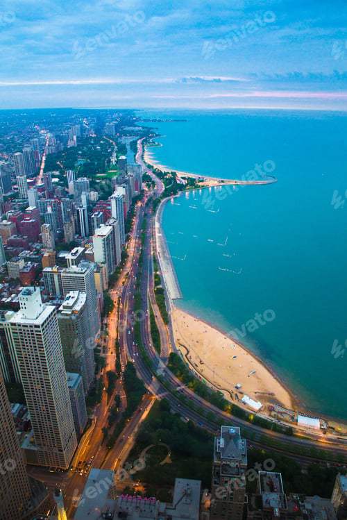 Preview: View Of Chicago Illinois And Lake Michigan With Beaches, Buildings And Roads In View At Sunset