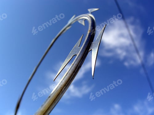 Preview: Sharp Razor Wire Against Blue Sky