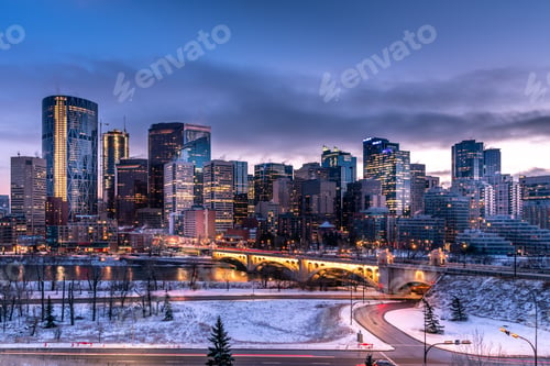 Preview: View Of Calgary'S Skyline On A Cool Evening In Winter. Bow River Is Visible In The Foreground.