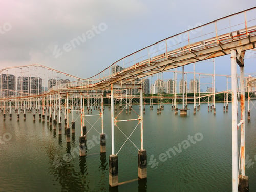 Preview: Abandoned Old Rusty Rollercoaster Track On Water - Landscape Color Photo