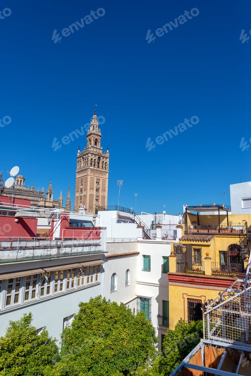 Preview: Apartment Buildings With La Giralda Bell Tower Of Seville Cathedral In The Background In Seville