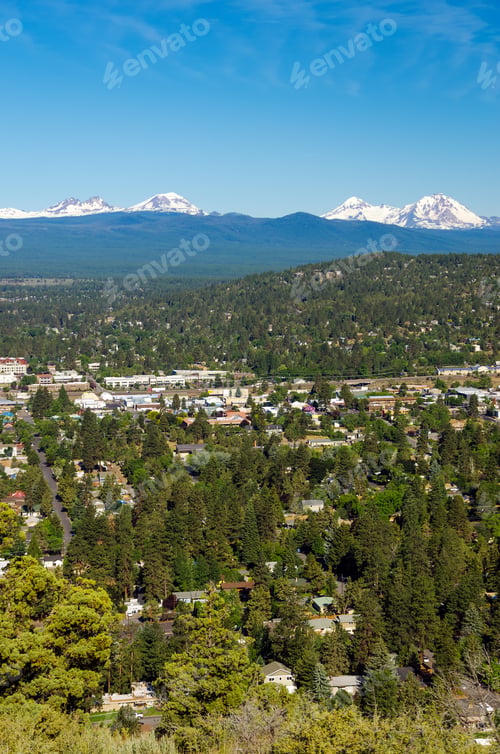 Preview: A Vertical Shot Of The City Of Bend With The Three Sisters Of The Cascade Range