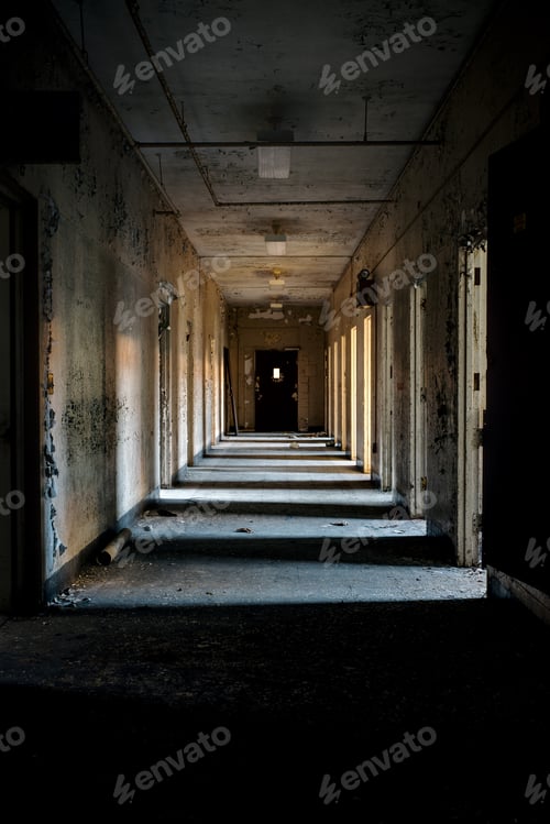 Preview: A Desolate Hallway With Open Doors Providing Some Light At A Long Abandoned Hospital.