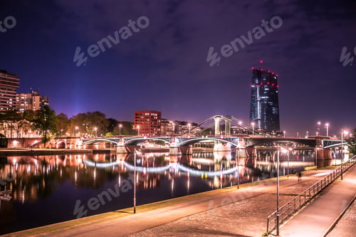 Preview: City Of Frankfurt Am Main In Germany Seen At Night With Lights, River, Buildings And Bridge.