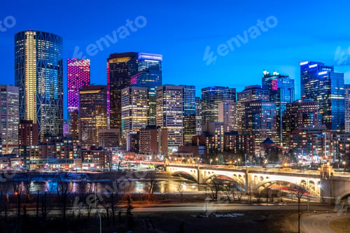 Preview: Calgary'S Modern Skyline At Night Along The Bow River.