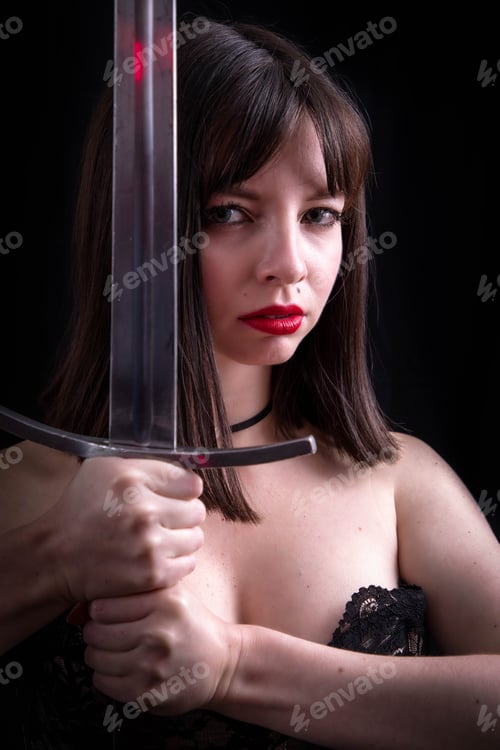 Preview: Attractive Girl Poses With Leather Corset And Medieval Sword In The Studio