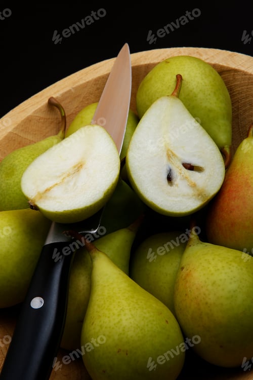 Preview: Ripe Organic Pear Fruit On A Rustic Bowl With Knife And Black Background