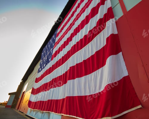 Preview: Over-Sized American Flag On The Facade Of A Red And White Building