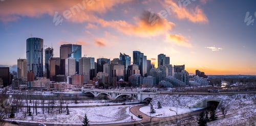 Preview: View Of Calgary'S Skyline On A Cool Evening In Winter. Bow River Is Visible In The Foreground.