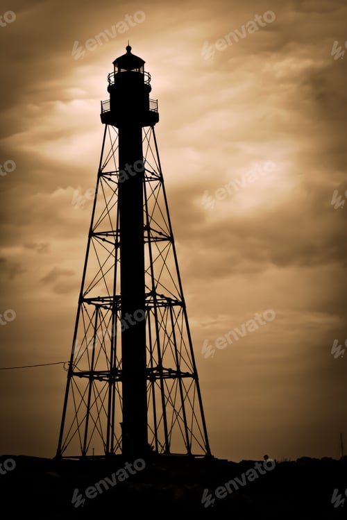 Preview: Marblehead Lighthouse In Massachusetts Silhouetted Against Eerie, Cloudy Golden Sky