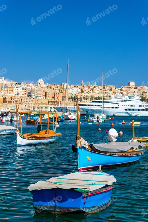 Preview: Traditional Maltese Boats With Superyachts In The Background With Valletta Visible In The