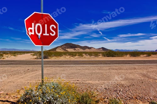 Preview: A Stop Sign In A Remote Area Of Arizona, Vandalized And Shot Up To The Point Of Barely Hanging Onto