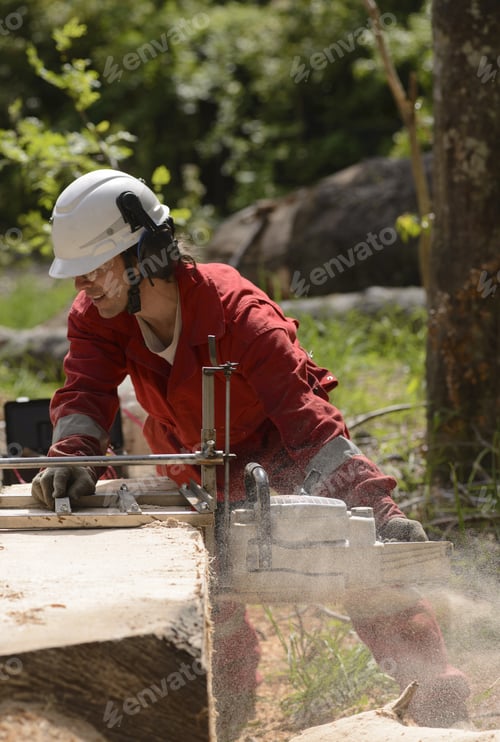 Preview: Man Cutting Wood With Chainsaw