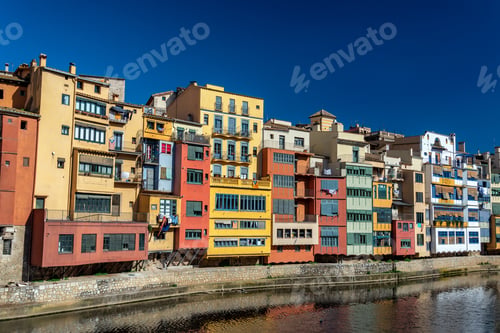 Preview: Beautiful Colorful Buildings On The Onyar River In Girona, Spain With A Deep Blue Sky