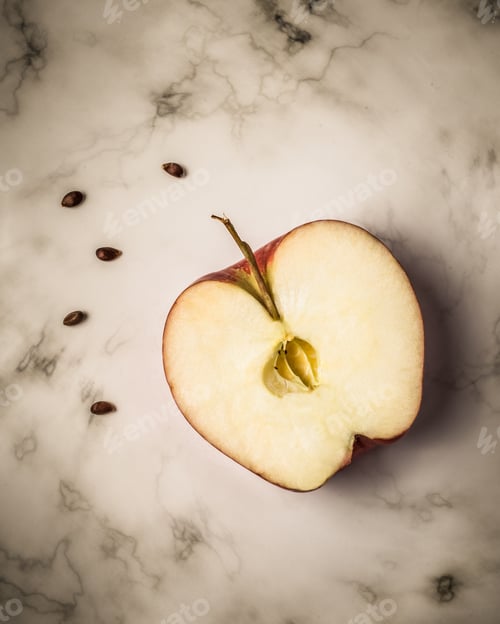 Preview: Apple Half With Seeds On Marble Surface