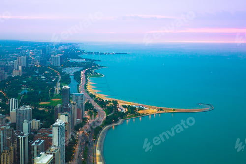 Preview: View Of Chicago Illinois And Lake Michigan With Beaches, Buildings And Roads In View At Sunset