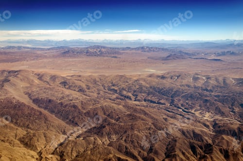 Preview: Dry Desert And Hills With Snow Capped Mountains In The Background Somewhere Over South America