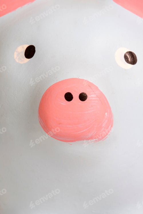 Preview: Close Of Pink And Blue Piggy Bank Looking On A Pile Of Money Coins. Isolated On White Background