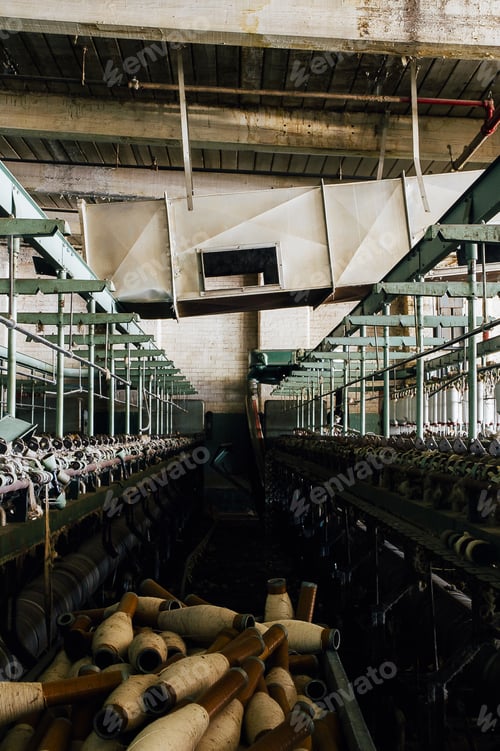 Preview: Old Yarn Spools And Rusting Industrial Equipment Awaits Its Fate At An Abandoned Textile Mill.