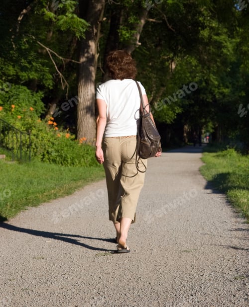 Preview: Color Dslr Picture Of A Fit Mature, Adult Woman Walking On A Path, From Behind. The Brunnette Is