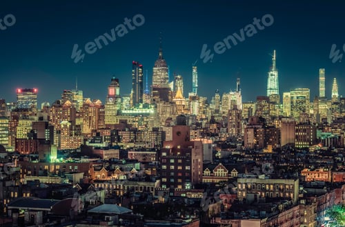Preview: New York Skyscrapers Panorama At Night. City Lights With Blue Sky