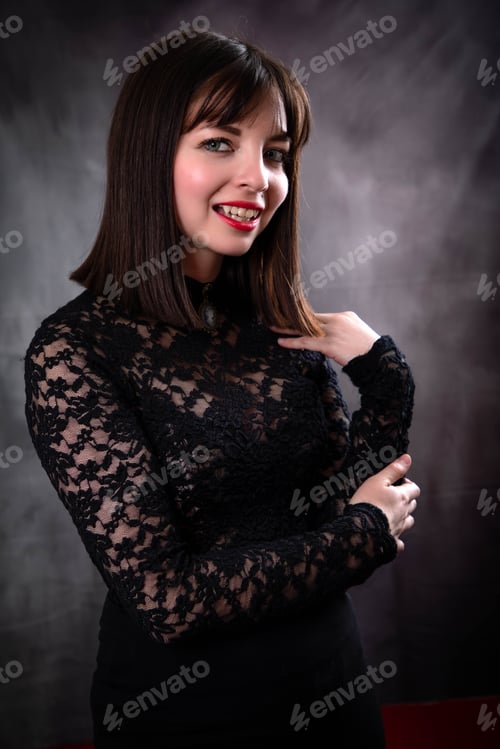 Preview: Young Vampire Woman With Short Hair, Pale Skin In A Black Dress On A Silver Background With Fangs
