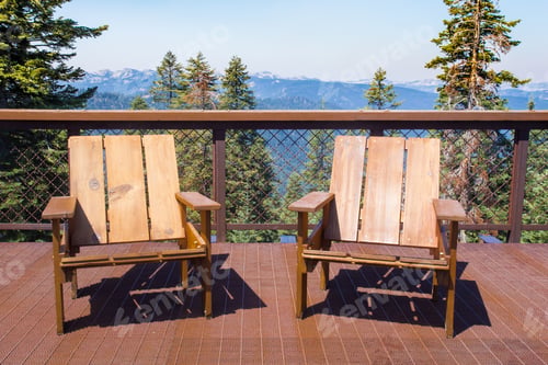 Preview: Two Wood Chairs On Outdoor Sunny Deck With Mountains In The Background