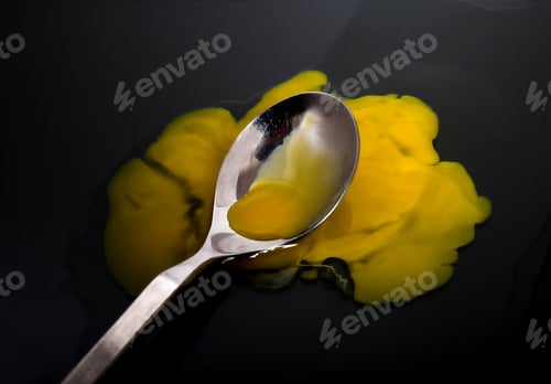 Preview: Broken Egg Yolk And Spoon