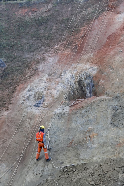 Preview: Worker Hanging On Rock With Safety Equipment