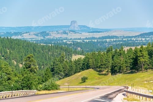 Preview: Highway In Wyoming With Devils Tower National Monument Visible In The Background
