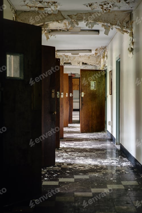 Preview: An Interior View Of A Disused Hallway With Open Doors At A Long Abandoned Hospital.