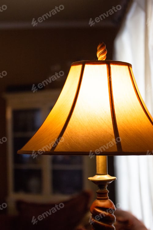 Preview: Illuminated Lamp With Shade In A Dimly Lit Room