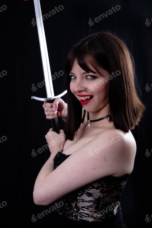 Preview: Attractive Girl Poses With Leather Corset And Medieval Sword In The Studio