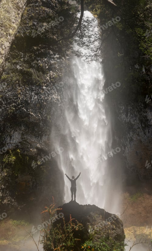 Preview: Woman On Top Of The Stone Looking At The Majestic And Imposing Waterfall.