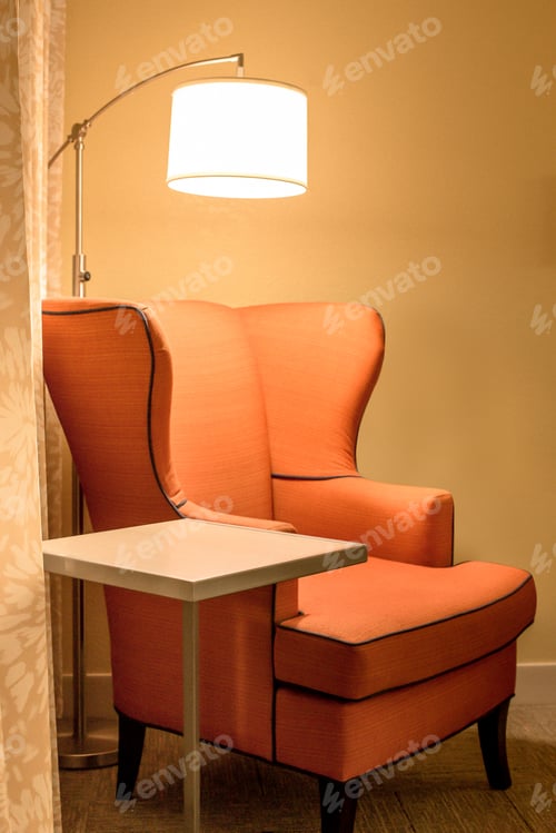 Preview: Orange Upholstered Armchair And Light In Comfortable Interior Setting