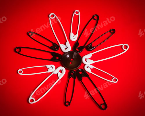 Preview: White And Black Safety Pins In Circular Pattern On Red Background