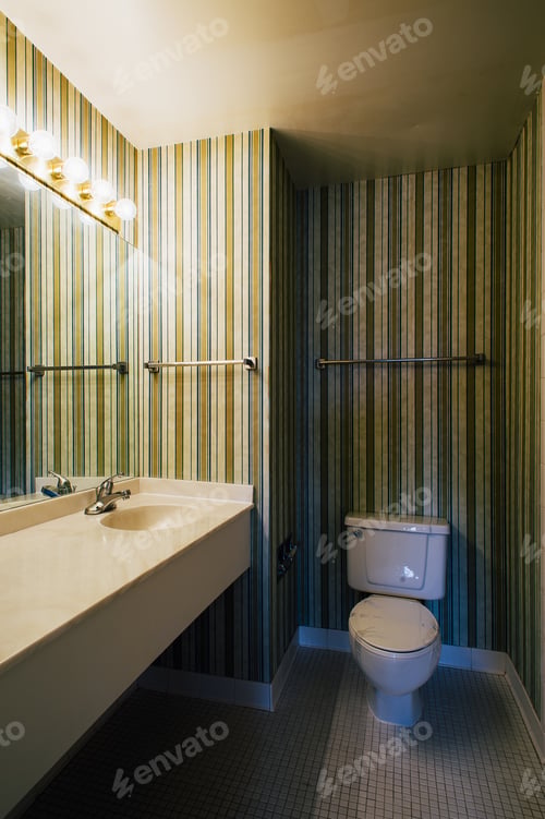 Preview: Striped, Vertical Wallpaper Is Present In A Clean Bathroom Which Contains A Sink And Toilet At A