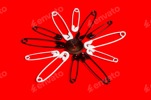 Preview: White And Black Safety Pins In Circular Pattern On Red Background