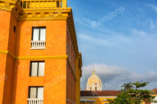 Preview: Orange Colonial Building In Cartagena, Colombia With The Dome Of The San Pedro Claver Church In The