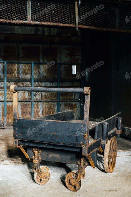 Preview: An Antique Wood Hand Cart With Cast Iron Wheels Remains Inside An Abandoned Glass Manufacturing
