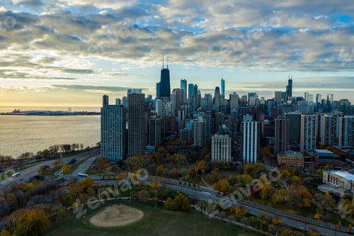 Preview: Aerial View Of Chicago Downtown Skyline With Park And The Beach. Sunrise Above Tall Buildings