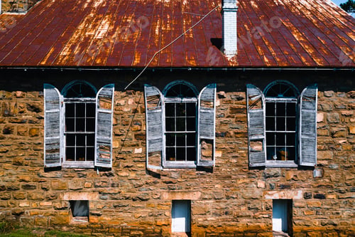 Preview: This Is An Exterior View Of Derelict Wood Shutters And Windows Against Sandstone At The Abandoned