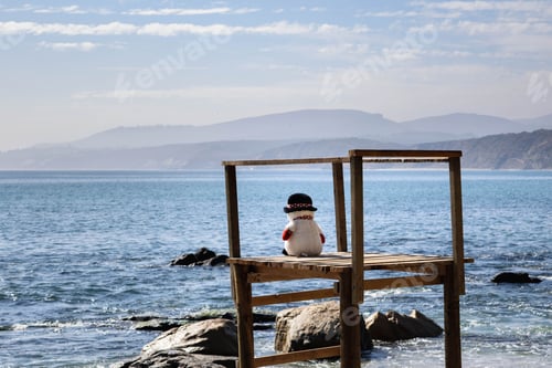 Preview: Snowman At The Beach Sitting On Surveillance Tower. Lifeguard. Vacation. Summer Work Concept.