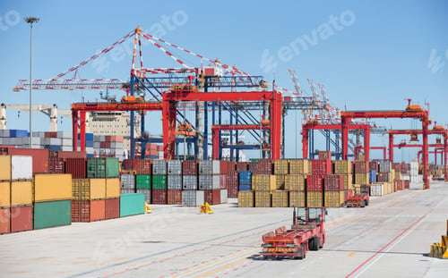 Preview: Wide Shot Of Cargo Containers And Cranes Alongside A Container Ship Moored At A Commercial Dock