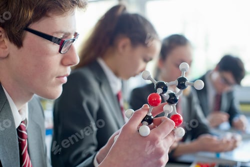 Preview: Close Up Shot Of A High School Student Examining A Molecule Model In A Science Class.