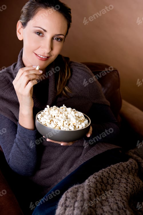 Preview: A Mid Adult Woman Eating Popcorn