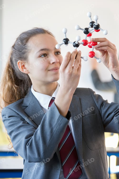 Preview: Smiling High School Student Examining Molecule Model In Science Class